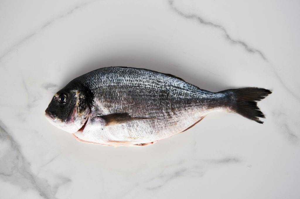 A fish on a marble table—a part of the Mediterranean diet.